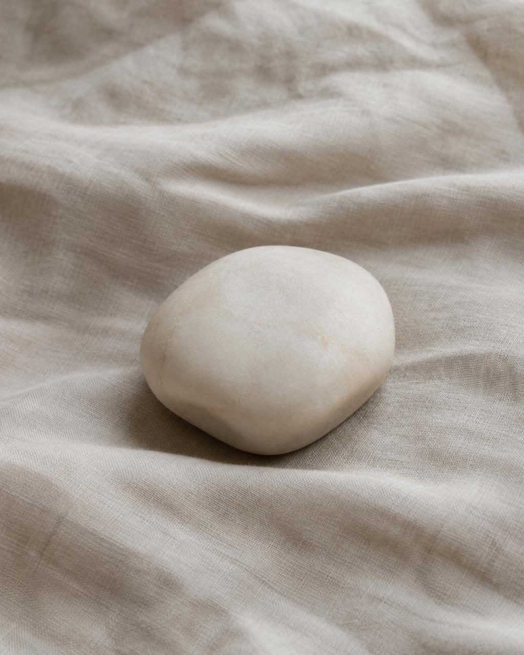 Smooth ivory stone on linen